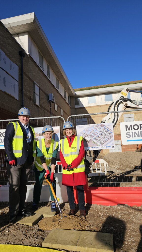 Emergency Medicine Consultant Dr Kate Coates holding the ceremonial spade flanked by Deputy Chief Executive Dr Andy Heeps and Worthing West MP Dr Beccy Cooper