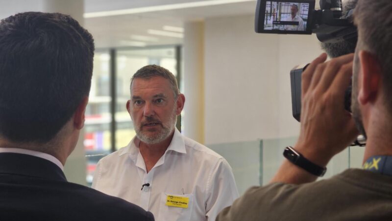 Image of Dr George Findlay with news crews at the Louisa Martindale Building